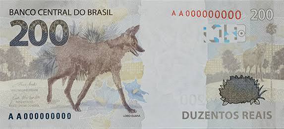 Nota de duzentos reais do Banco Central do Brasil, apresentando a imagem de um lobo-guará e elementos naturais ao fundo.